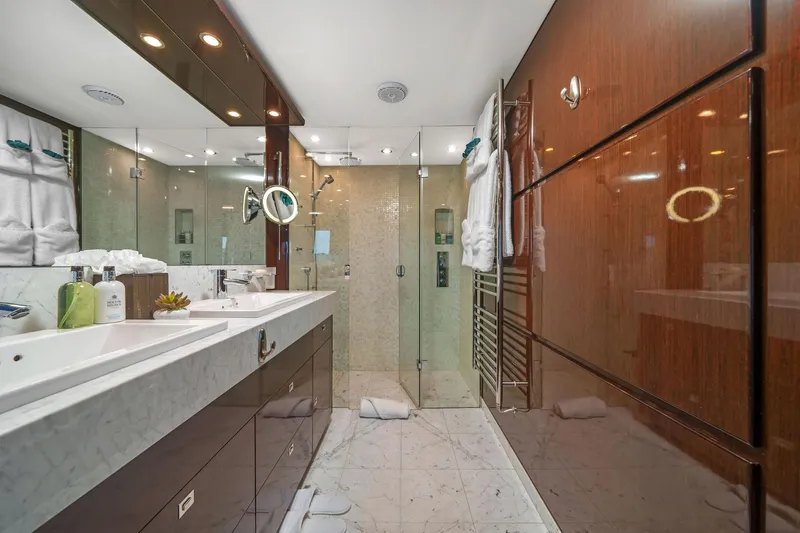 Slide: The Image of Luxurious yacht bathroom with dual sinks, glass shower, and elegant wood paneling, Princess 95, 2011. - 39