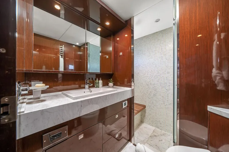 Slide: The Image of Luxurious yacht bathroom with marble sink, wooden cabinetry, and modern fixtures on a 2011 Princess 95. - 45
