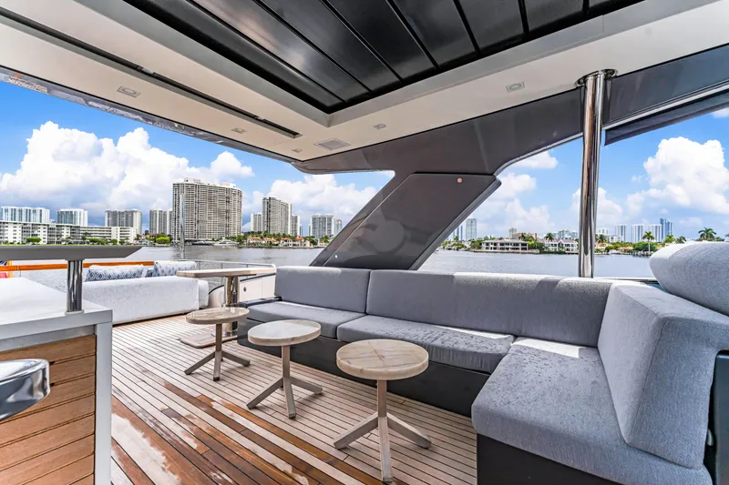 Slide: The Image of Luxurious 2018 Sanlorenzo SL78 yacht deck with modern seating and city skyline view. - 9