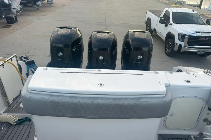 Slide: The Image of 2007 Fountain 38 Sportfish Cruiser OB with four outboard engines at a dock. - 12