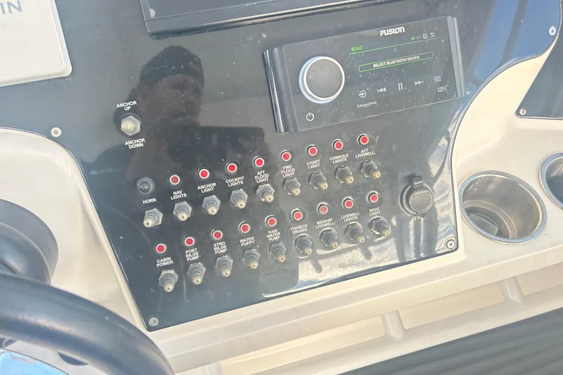 Slide: The Image of Control panel of a 2007 Fountain 38 Sportfish Cruiser OB with switches and a Fusion stereo. - 29