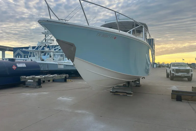 Slide: The Image of 2007 Fountain 38 Sportfish Cruiser OB on dock, with sunset and truck in background. - 3