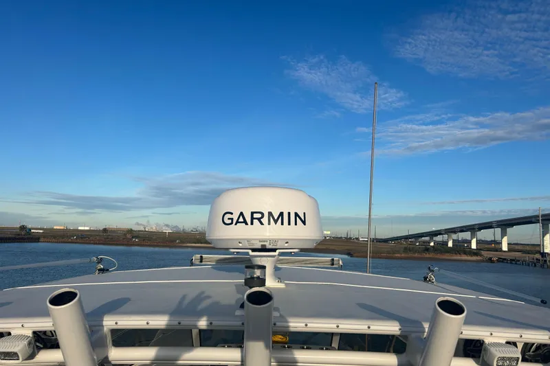 Slide: The Image of 2007 Fountain 38 Sportfish Cruiser OB with Garmin radar, under clear blue sky. - 44