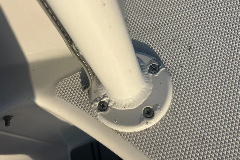 Slide: The Image of Close-up of a 2007 Fountain 38 Sportfish Cruiser OB boat's metal fixture with screws. - 52