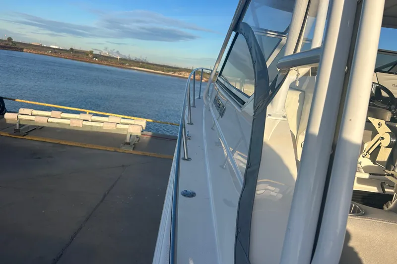 Slide: The Image of 2007 Fountain 38 Sportfish Cruiser OB docked by the water on a sunny day. - 54