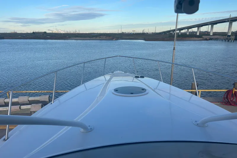 Slide: The Image of 2007 Fountain 38 Sportfish Cruiser OB docked by a calm waterfront. - 7