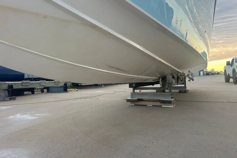 Slide: The Image of 2007 Fountain 38 Sportfish Cruiser OB on dry dock, side view at sunset. - 8