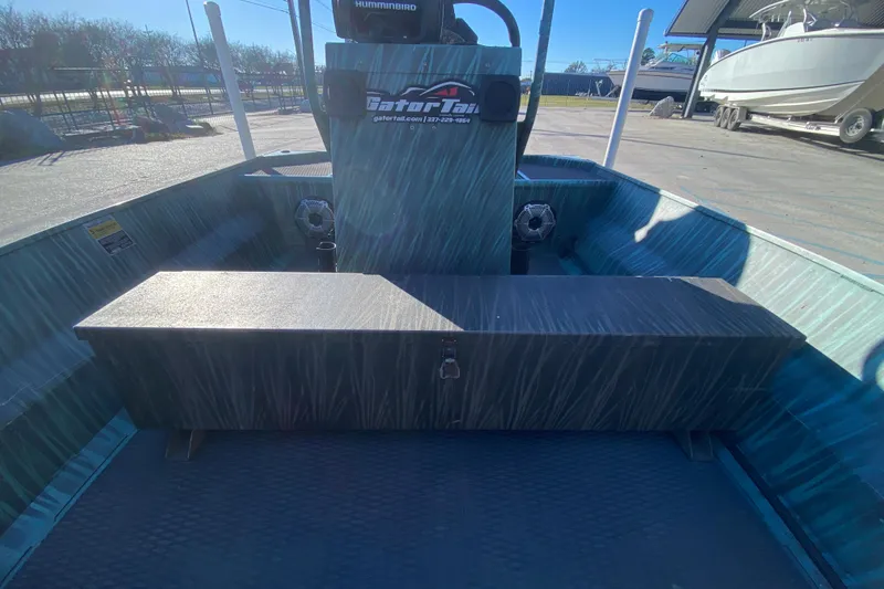 Slide: The Image of 2015 Gator Tail 18' boat interior with storage compartment and console. - 18
