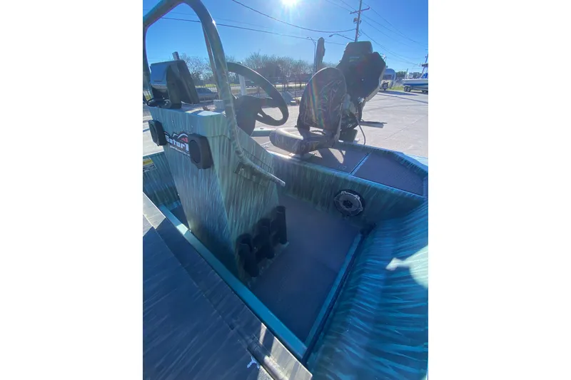 Slide: The Image of 2015 Gator Tail 18' boat interior with steering console and seating. - 19