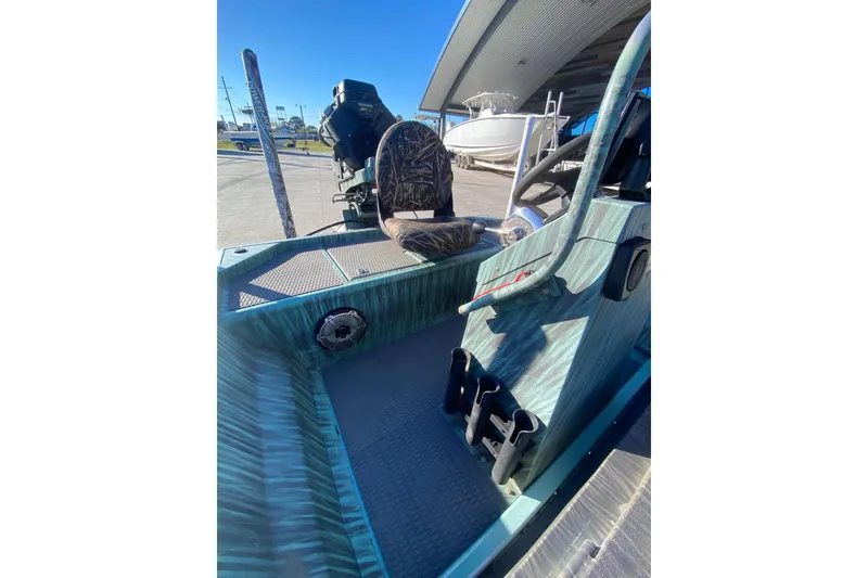 Slide: The Image of 2015 Gator Tail 18' boat interior with camouflage seat and steering console. - 20