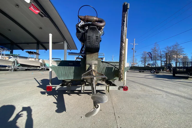 Slide: The Image of 2015 Gator Tail 18' boat with motor, parked outdoors under clear blue sky. - 5
