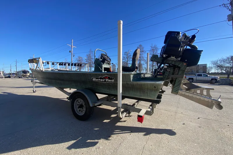 Slide: The Image of 2015 Gator Tail 18' boat on trailer, parked outdoors under clear blue sky. - 6