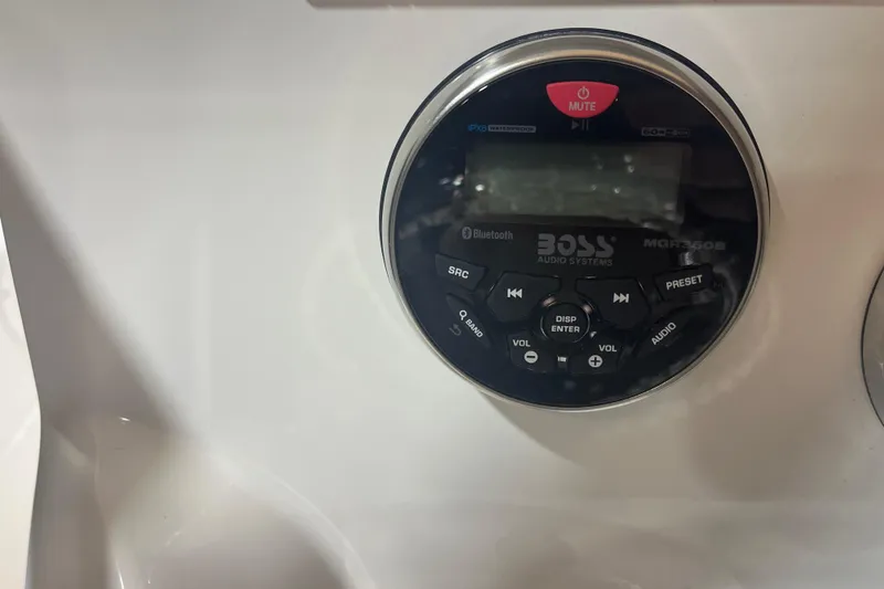 Slide: The Image of BOSS audio system on 2023 NauticStar 227 XTS boat dashboard, featuring Bluetooth and waterproof design. - 10