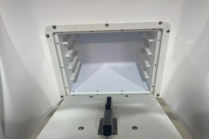 Slide: The Image of Storage compartment of 2023 NauticStar 227 XTS boat, featuring a secure latch mechanism. - 15