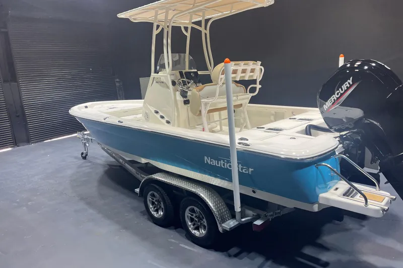Slide: The Image of 2023 NauticStar 227 XTS boat with Mercury engine on trailer in showroom. - 3