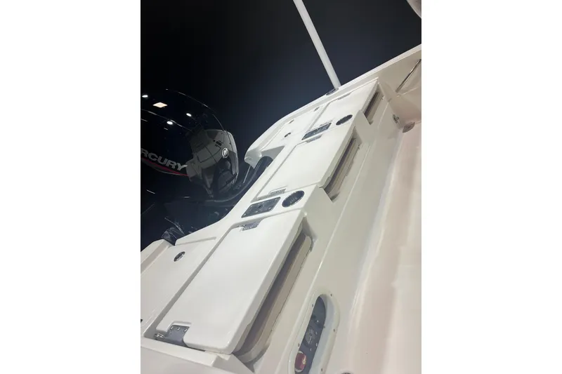 Slide: The Image of 2023 NauticStar 227 XTS boat with Mercury engine, showcasing sleek design and storage compartments. - 5