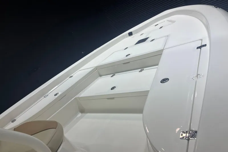 Slide: The Image of 2023 NauticStar 227 XTS boat interior with sleek white design and storage compartments. - 8