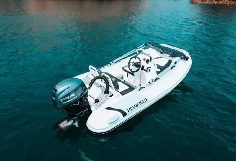 Slide: The Image of 2024 Highfield Sport 330 boat on clear blue water. - 3