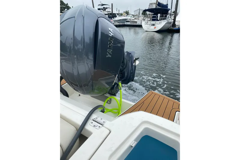Slide: The Image of 2022 Cobia 240 Dual Console boat with Yamaha outboard motor in marina. - 5