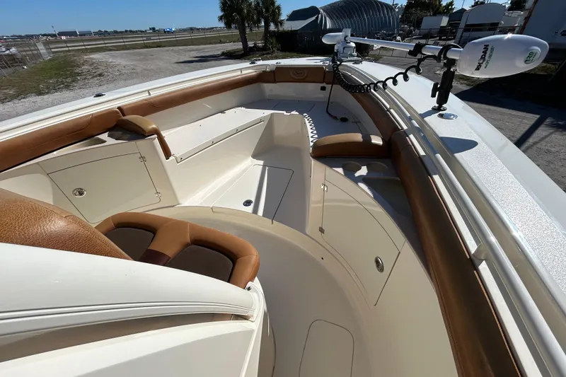 Slide: The Image of 2016 Scout 275 LXF boat interior with tan seating and storage compartments. - 16