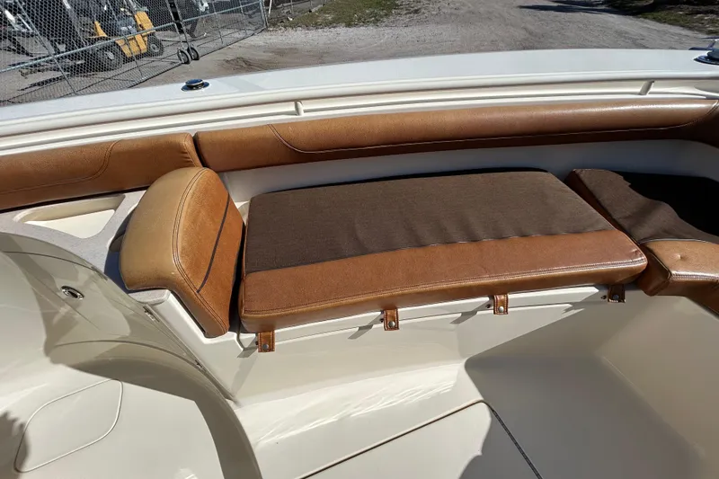 Slide: The Image of 2016 Scout 275 LXF boat interior with brown cushioned seating. - 19