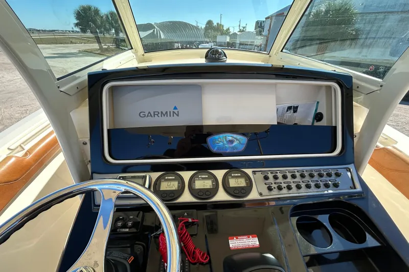 Slide: The Image of 2016 Scout 275 LXF boat dashboard with Garmin navigation system and Yamaha controls. - 26