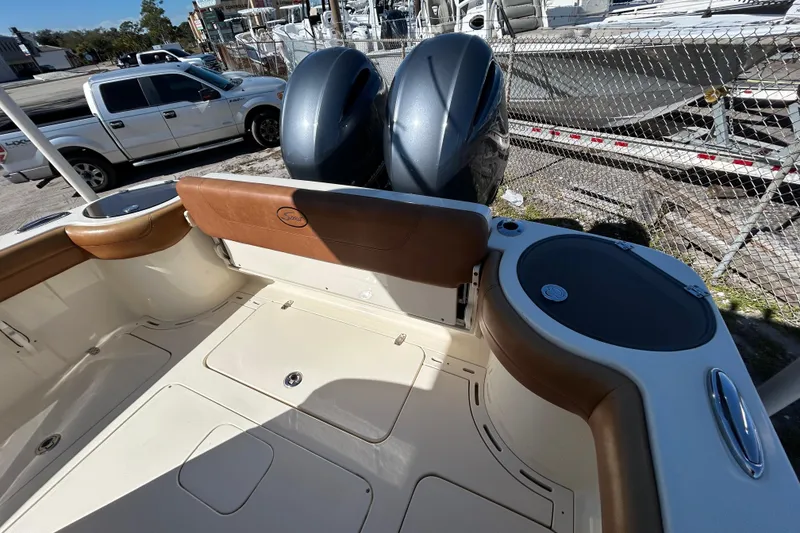 Slide: The Image of 2016 Scout 275 LXF boat interior with dual engines and seating area. - 8
