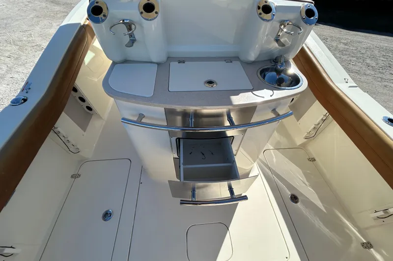 Slide: The Image of 2016 Scout 275 LXF boat interior with storage and sink area. - 9