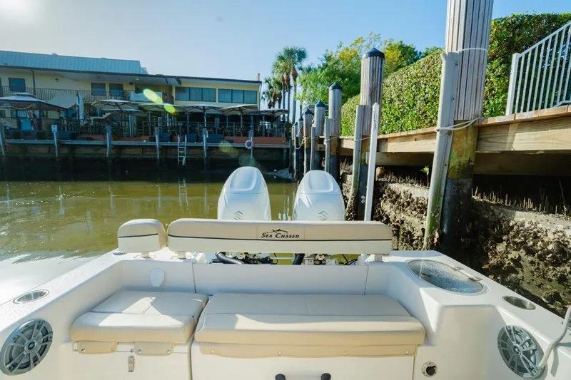 Slide: The Image of 2022 Sea Chaser 24 HFC boat docked near waterfront restaurant. - 11