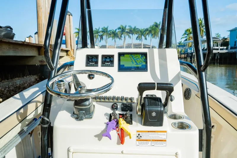 Slide: The Image of 2022 Sea Chaser 24 HFC boat console with steering wheel and navigation display. - 12
