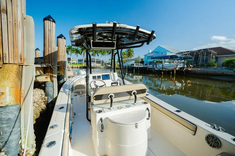 Slide: The Image of 2022 Sea Chaser 24 HFC boat docked in a sunny marina setting. - 15