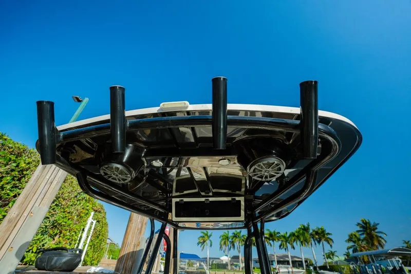 Slide: The Image of 2022 Sea Chaser 24 HFC boat with rod holders and speakers under a clear blue sky. - 19