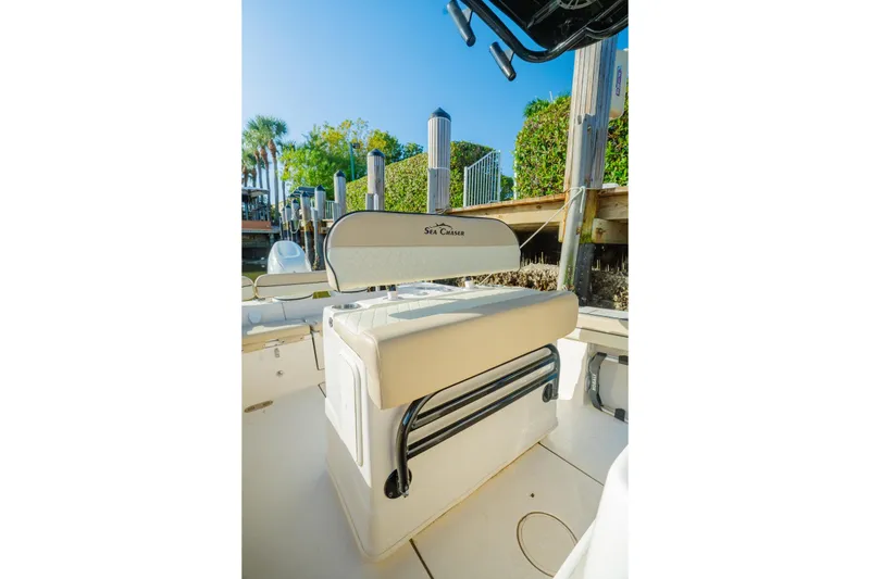 Slide: The Image of 2022 Sea Chaser 24 HFC boat interior with seating and dock view. - 5