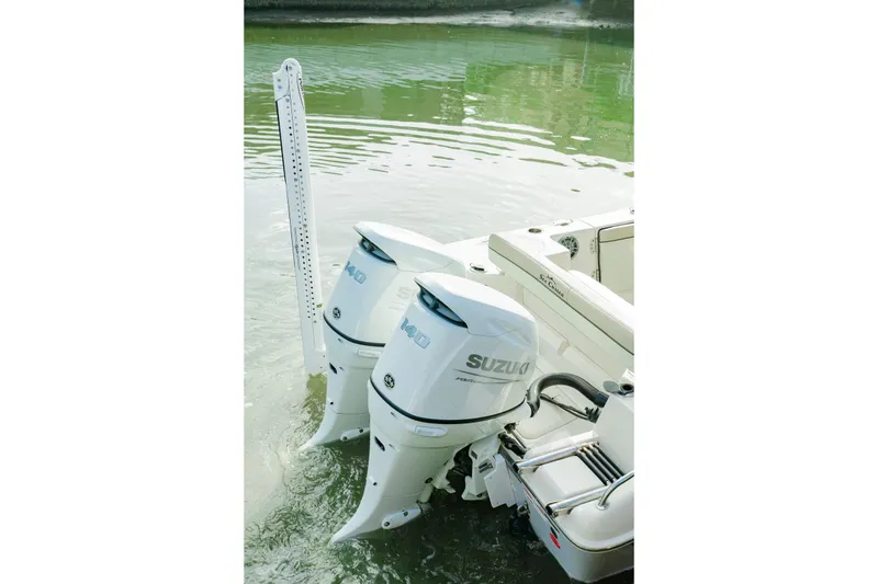 Slide: The Image of 2022 Sea Chaser 24 HFC with dual Suzuki outboard motors on calm water. - 6