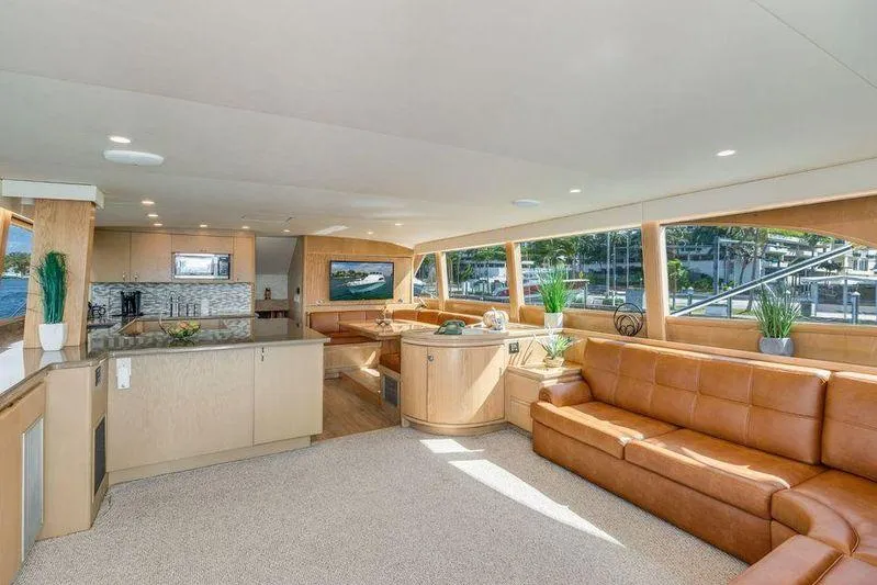 Slide: The Image of Luxurious interior of a 1992 Huckins 70 Convertible yacht with modern furnishings and large windows. - 10