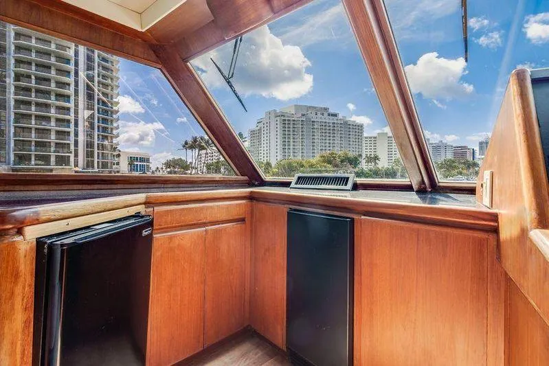 Slide: The Image of Interior view of 1992 Huckins 70 Convertible yacht with cityscape through windows. - 11
