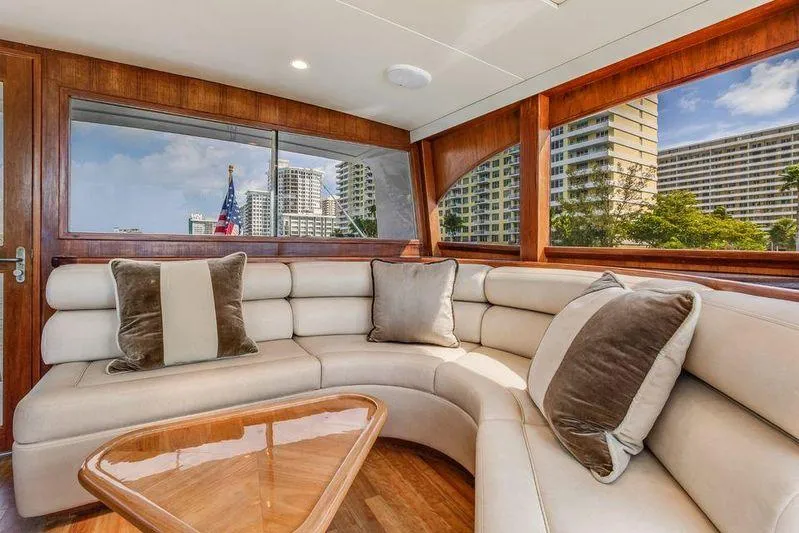 Slide: The Image of Luxurious interior of a 1992 Huckins 70 Convertible yacht with plush seating and cityscape views. - 12