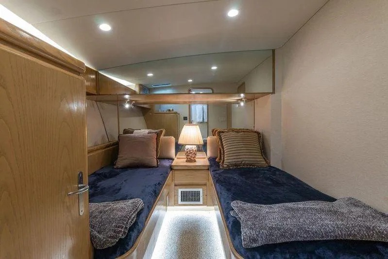 Slide: The Image of Luxurious 1992 Huckins 70 Convertible yacht cabin with twin beds and elegant decor. - 14
