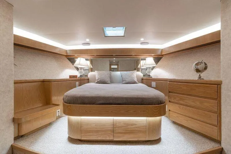 Slide: The Image of Luxurious bedroom interior of 1992 Huckins 70 Convertible yacht with elegant wood finishes. - 15