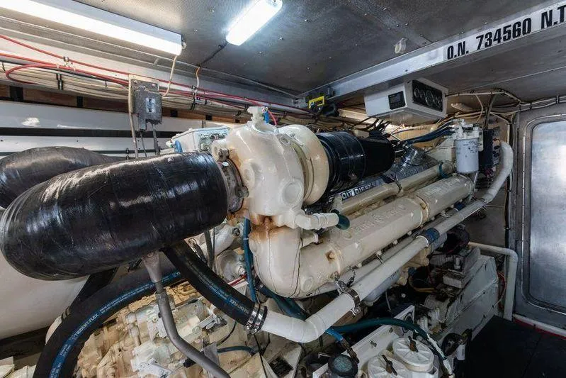 Slide: The Image of Engine room of a 1992 Huckins 70 Convertible yacht, showcasing mechanical components. - 19