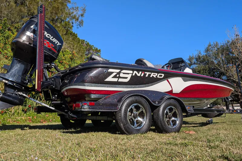 Slide: The Image of 2015 Nitro Z-9 boat with Mercury engine on grassy area under clear blue sky. - 5