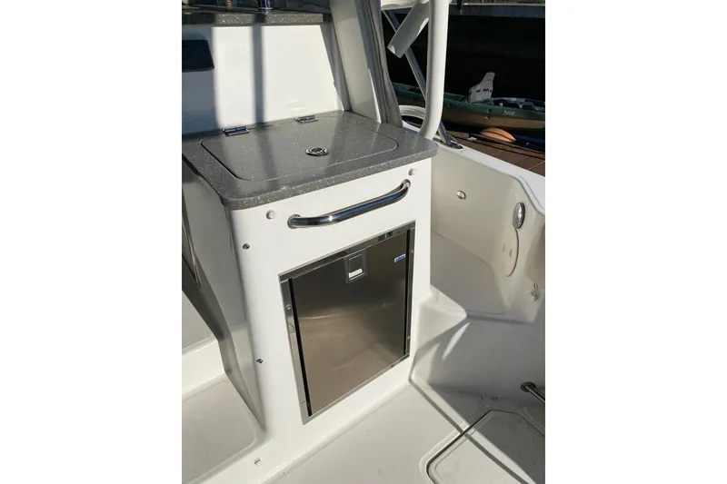 Slide: The Image of 2021 Boston Whaler 345 Conquest boat interior with compact kitchenette and storage. - 12