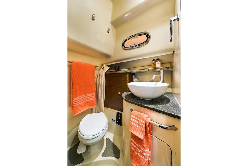 Slide: The Image of Manufacturer Provided Image: 2021 Boston Whaler 345 Conquest bathroom with modern sink and orange towels. - 21