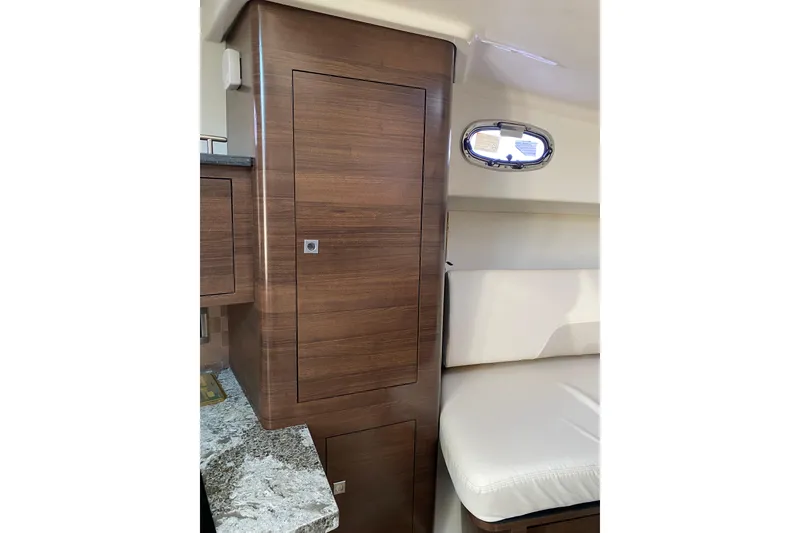 Slide: The Image of 2021 Boston Whaler 345 Conquest interior with wood cabinetry and seating. - 23