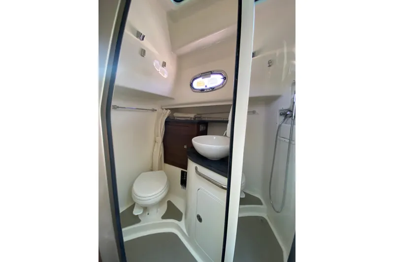 Slide: The Image of 2021 Boston Whaler 345 Conquest bathroom with toilet, sink, and shower. - 26
