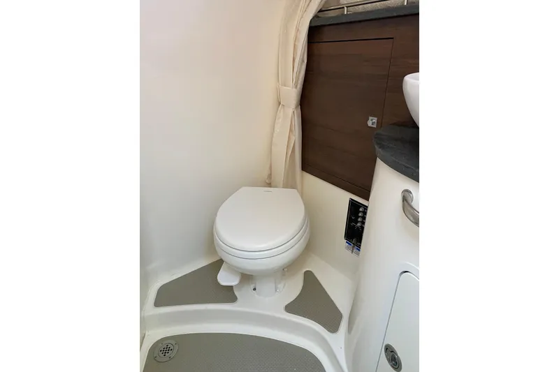 Slide: The Image of 2021 Boston Whaler 345 Conquest bathroom interior with toilet and wooden cabinetry. - 27