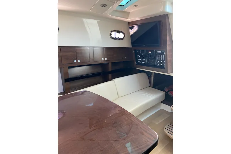 Slide: The Image of Interior of 2021 Boston Whaler 345 Conquest with sofa, table, and control panel. - 30