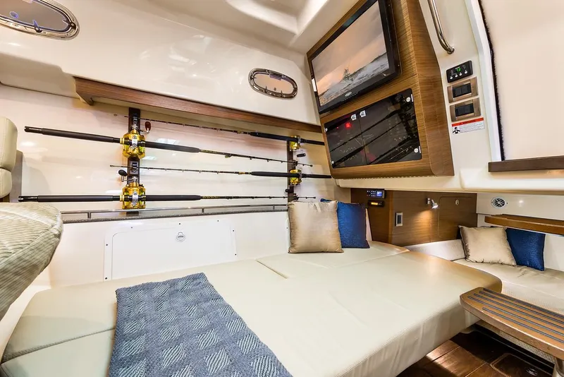 Slide: The Image of Manufacturer Provided Image: Interior cabin of 2021 Boston Whaler 345 Conquest with fishing rods and TV. - 31