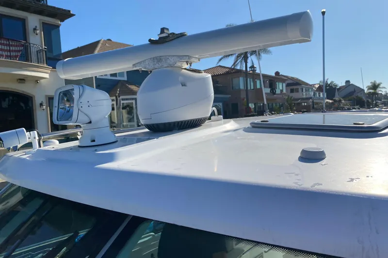 Slide: The Image of 2021 Boston Whaler 345 Conquest radar and spotlight on deck, coastal background. - 5