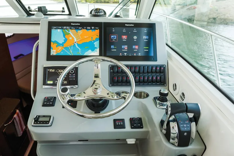Slide: The Image of Manufacturer Provided Image: 2021 Boston Whaler 345 Conquest helm with dual Raymarine displays and advanced controls. - 7